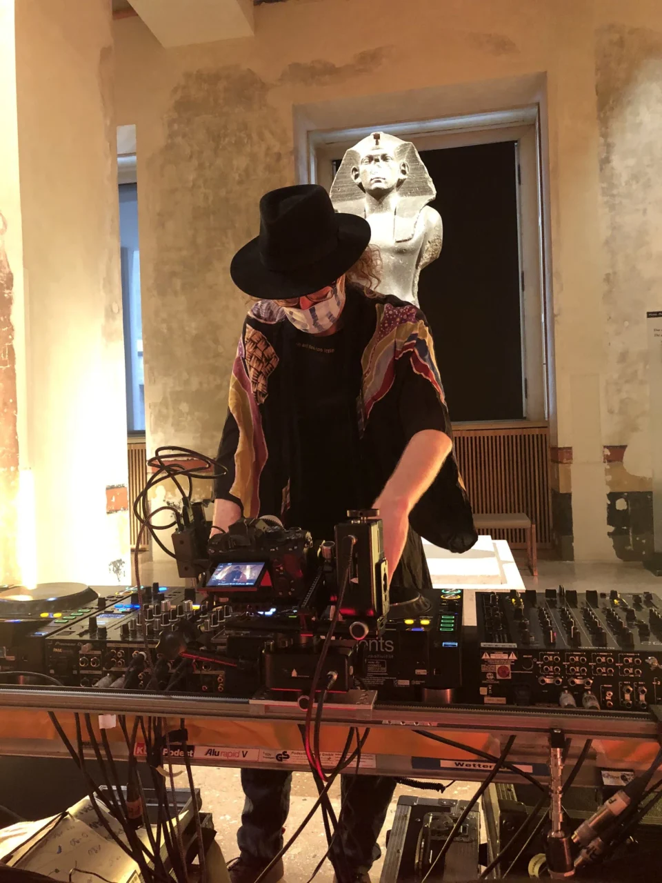 Acid Pauli performs at the decks with an Egyptian statue behind him in Neues Museum.