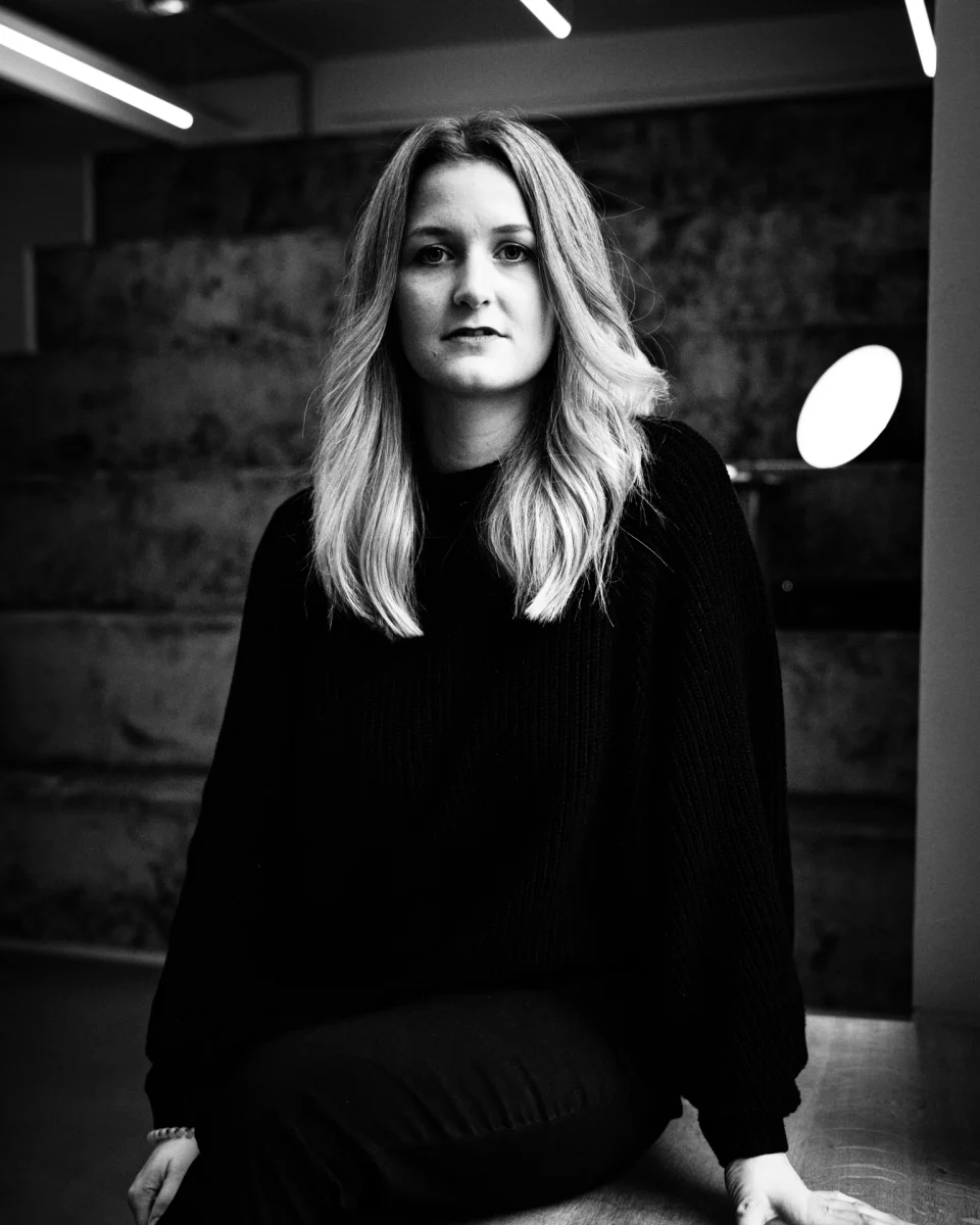 A black-and-white portrait framed by a doorway.