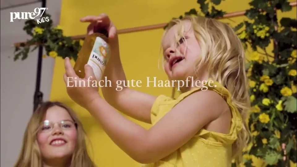 Children in yellow clothing beneath an outdoor shower in the pure97 Kids film.